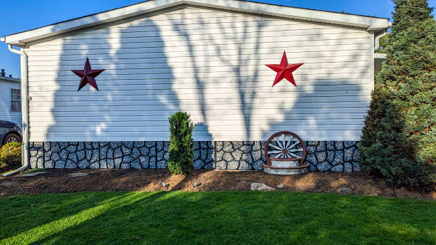 istock White Mobile, Manufactured, Prefab Home With Red Stars And Decorative Wagon Wheel 2158569906