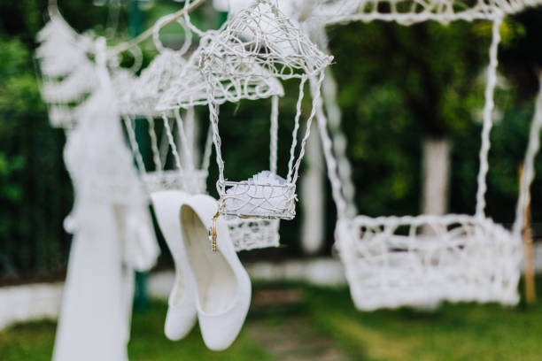 white wedding shoes with a bow on a heel on a green background