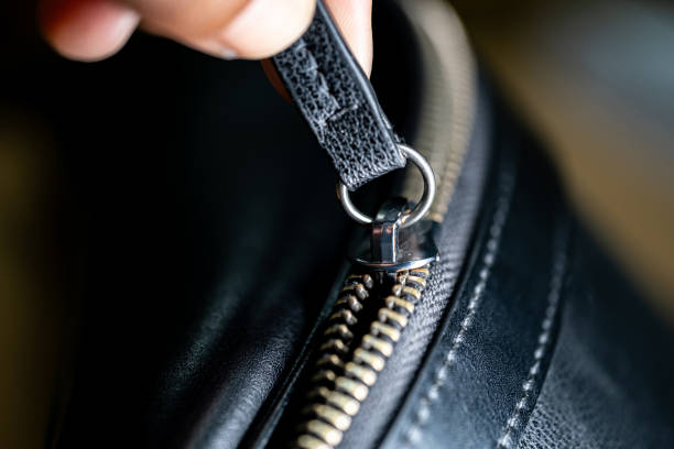 istock Hand Holding Zipper on Black Leather Bag 2158573320
