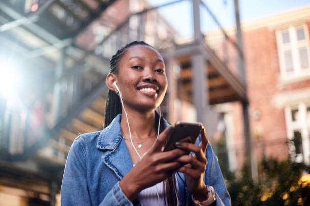 istock Connected Joy: Smiling Young Woman Engaged in Messaging 2158577285