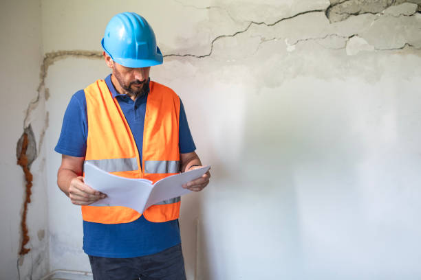 istock Real estate property appraisal engineer studying the blueprints. 2158577928