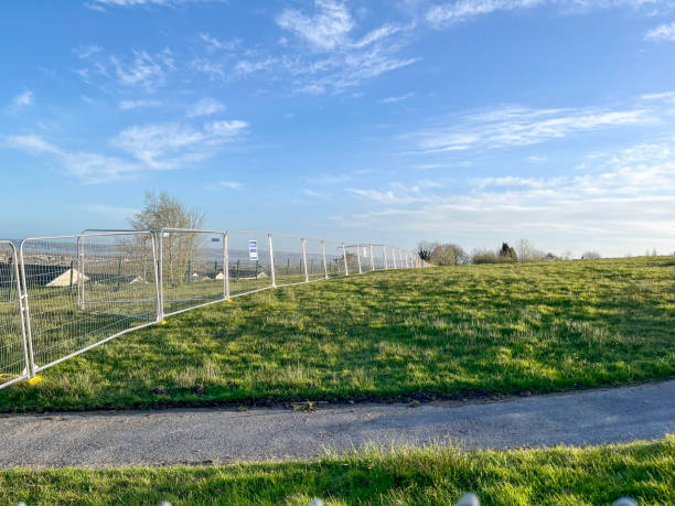 istock Temporary metal barrier running across field 2158578519