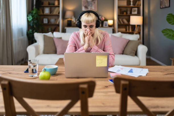 istock Young introvert freelancer businesswoman with ADHD working remotely from home office on laptop computer. Business person avoiding crowded office and people by working alone at apartment on computer. 2158580294