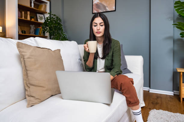 istock Young introvert freelancer businesswoman with ADHD working remotely from home office on laptop computer. Business person avoiding crowded office and people by working alone at apartment on computer. 2158580325