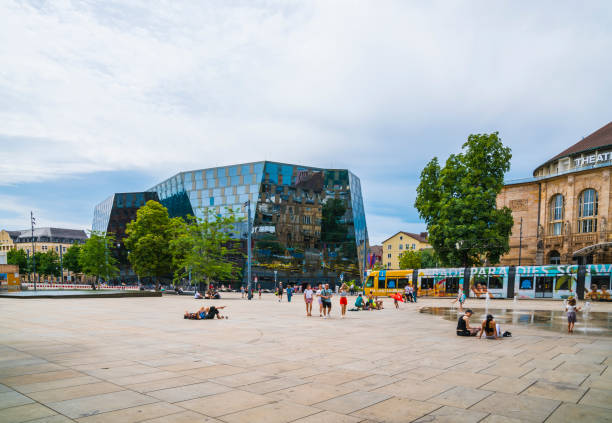 Freiburg im Breisgau, Germany, July 23, 2023, Famous old synagogue square downtown surrounded by the theatre and library building with many students and children enjoying the summer