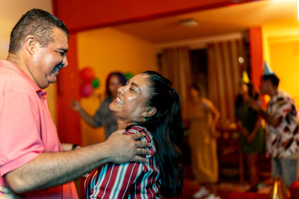 Mature couple dancing on party at home