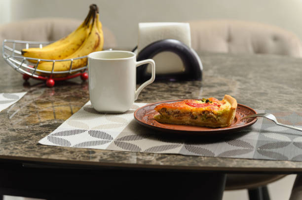 French quiche lauren with salmon, cheese and broccoli on white table. Soft focus