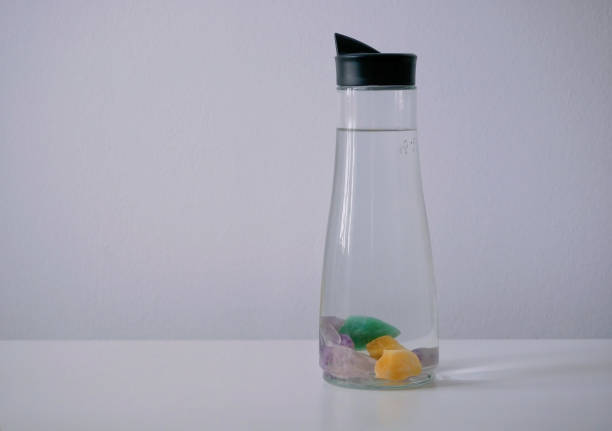 Gemstones for water mineralization. Natural water filter. Premium crystals for drinking water. Bottle with stones for health. Rock crystal, rose quartz, citrine, aventurine, selenite and amethyst.
