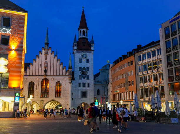 20th June 2024: Night time in Marienplatz in Munich's historic city centre. Dating back to 1158, when the city began, the pedestrian area is a popular location for shoppers and tourists. Badly bomb damaged in 1944 the square and surrounding buildings have been faithfully restored to their original style.