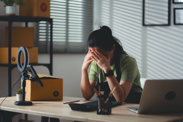 istock Asian woman online seller feels concerned thinking about work. 2158585779