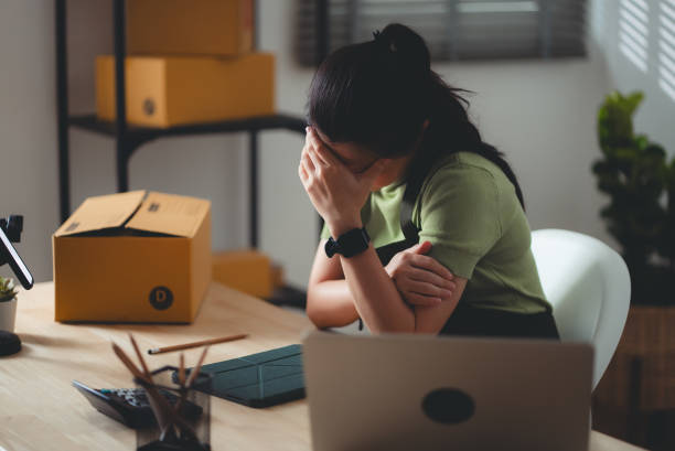 istock Asian woman online seller feels concerned thinking about work. 2158585956
