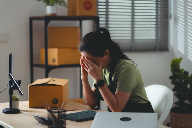 istock Asian woman online seller feels concerned thinking about work. 2158585987