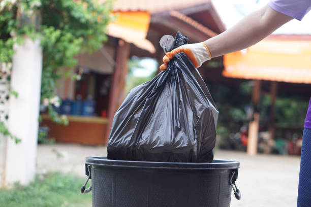 istock Hand holding garbage black bag putting in to the bin. Concept, garbage management, Keep clean for sanitary and community service for the best environment. Zero waste. 2158586552