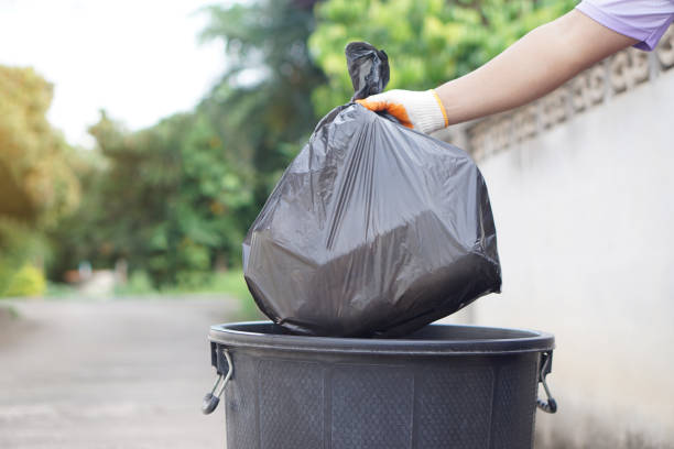 istock Hand holding garbage black bag putting in to the bin. Concept, garbage management, Keep clean for sanitary and community service for the best environment. Zero waste. 2158590516