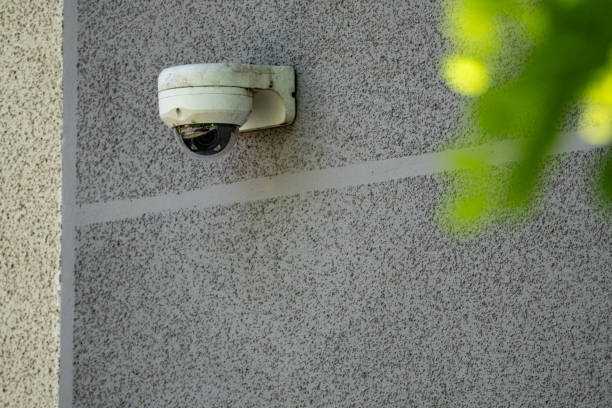 istock White Security Camera Mounted On Exterior Wall Of Building 2158592044