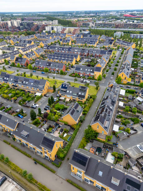Facade in row of Modern Real Estate Family houses in a suburban area in the Netherlands.  Drone shot.