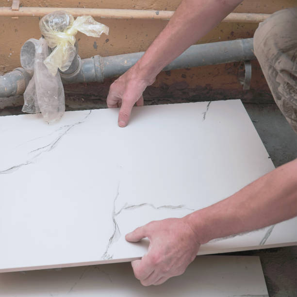 istock A male builder lays floor ceramic tiles 2158593763