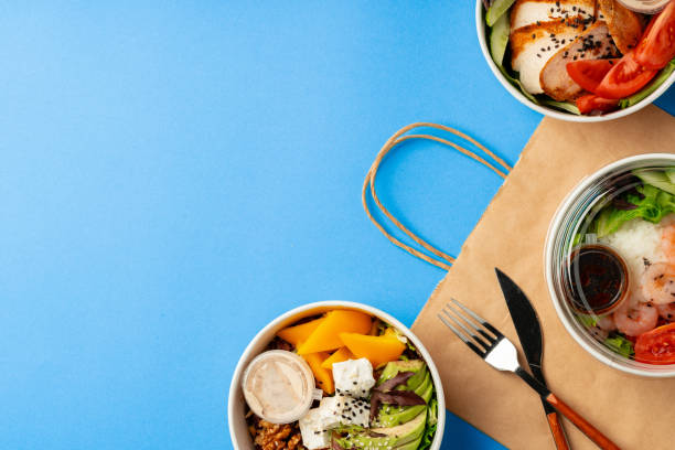 istock Different poke bowls on blue background top view 2158595361
