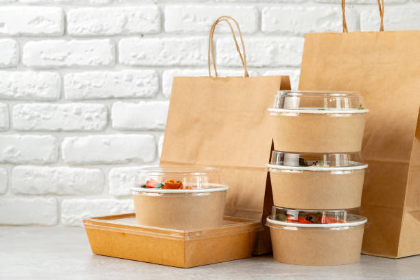 istock Take out food in boxes and craft bag against brick background 2158595373