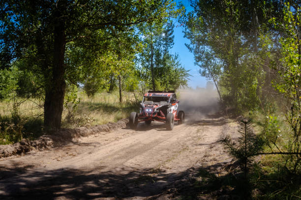 Outdoor activities UTV buggy moves on dusty road. 4x4, extreme, adrenalin.