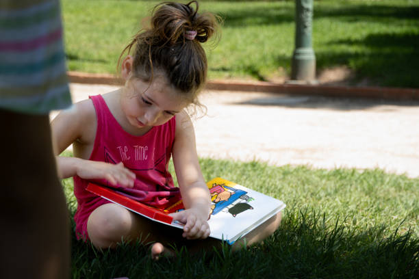 Girl enjoying her vacation on the grass. Students on vacation from school.