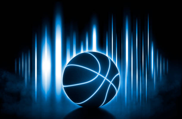 istock A black basketball ball has bright blue glowing neon lines on blue light bokeh effect with smoke on black background 2158606739
