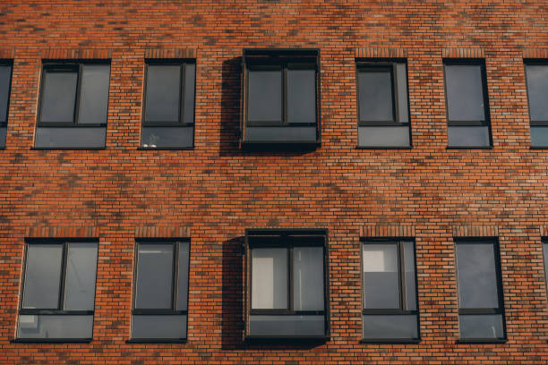 istock Brick red facade of modern office building, windows in row 2158611294