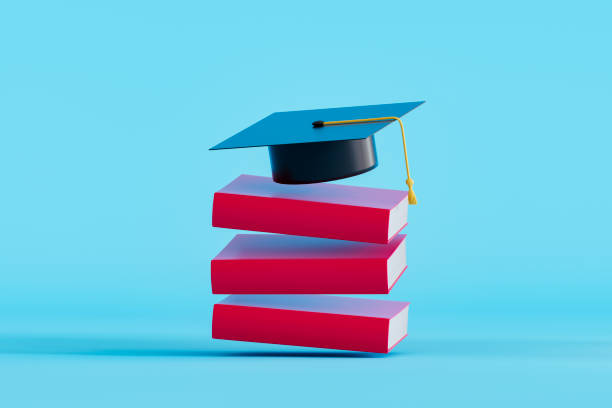 istock Graduation cap on flying stacked books, back to school concept 2158615934