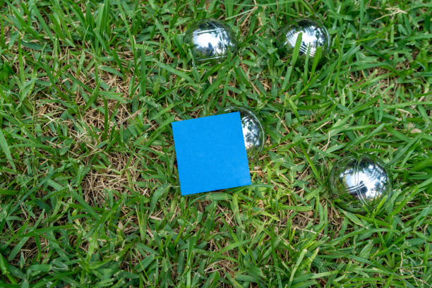 The game balls are on the grass, and there is a blue note