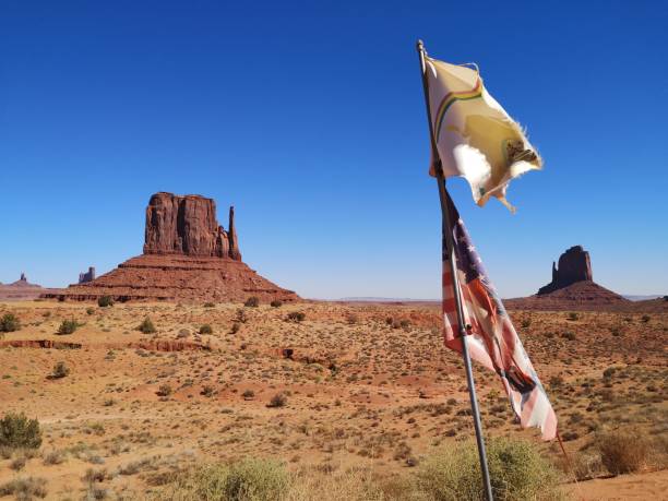 Vintage postcard of Monument Valley, showing U.S. Route 163 crossing the border between Utah and Arizona. Tourist destinations in Western USA, traveling on the road. Composite image with clipping path on white background.