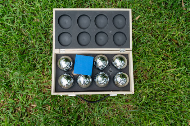 The game balls are on the grass, and there is a blue note