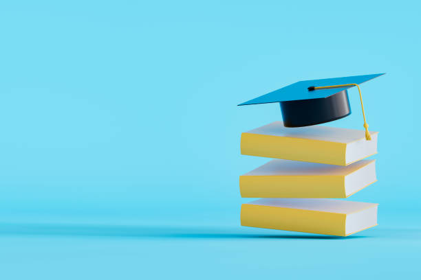 istock Graduation cap on flying stacked books, back to school concept 2158617684