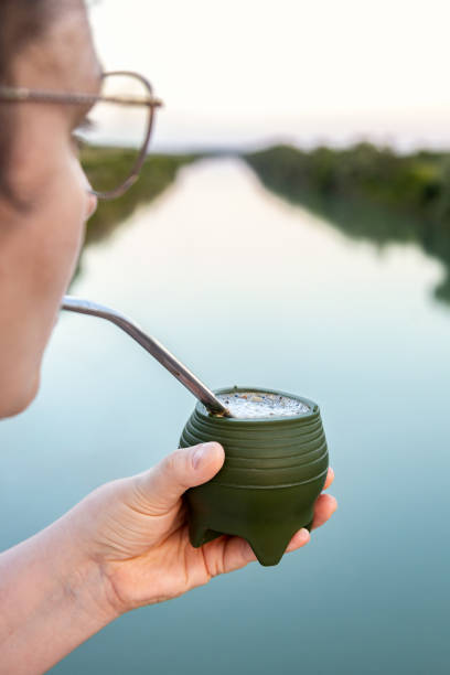 istock Woman drinking yerba mate (chimarrão) from a silicone mate gourd 2158618213