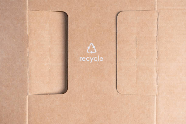 istock White recycle text and symbol on cardboard. 2158624121