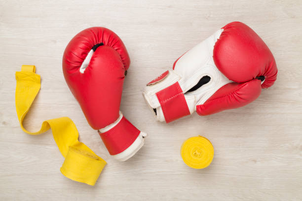 istock Red boxing gloves on wooden background, top view. 2158628091