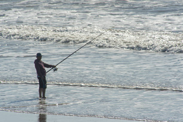 Santa Clara del Mar , Buenos Aires,Argentina;12-31-2018:Fisherman fishing on the beach