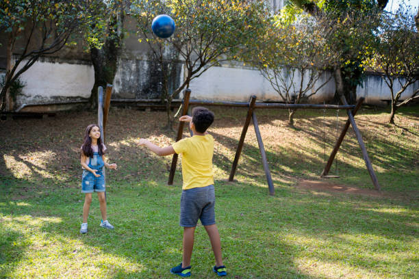istock Children playing with ball in a public park 2158629451