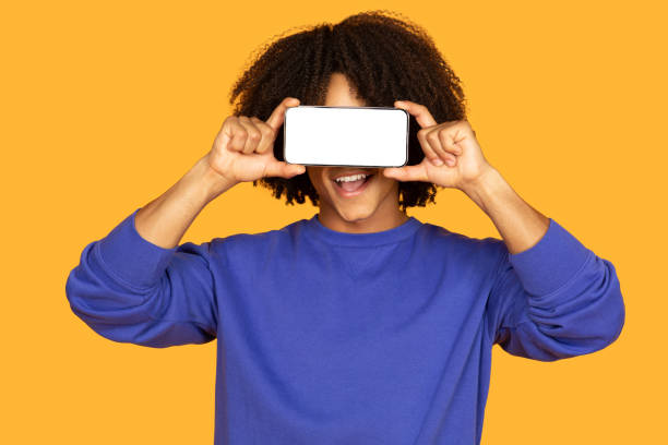 istock Curly Guy Holding Cell Phone to Face 2158629978