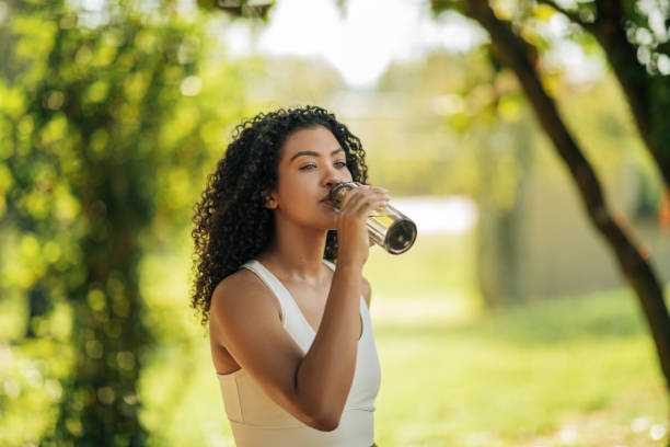 istock Athletic Woman Drinking From Bottle in Park 2158630027