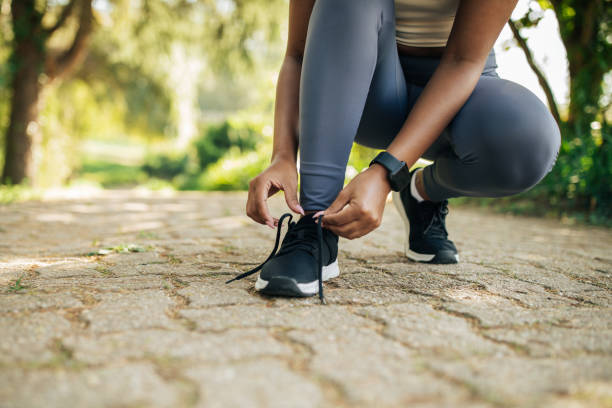 istock Woman Tying Shoelaces on Path, Cropped Shot 2158630036
