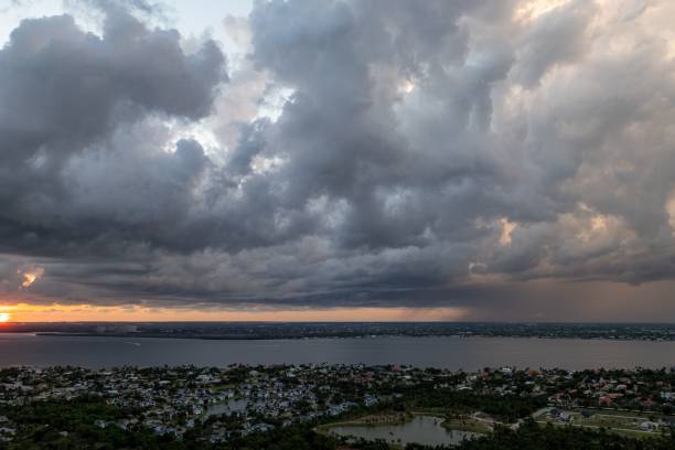 A dramatic cloudy sky over a coastal city at sunset