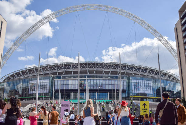 London, UK - October 22, 2018: supporters of Tottenham Hotspur FC walking on Wembley Way outside Wembley Stadium before a match in the Premier League, the top division in English football. Room for copy space.