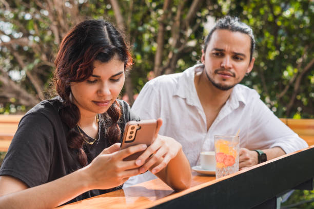 istock Girl ignores a guy to read a text message 2158632033