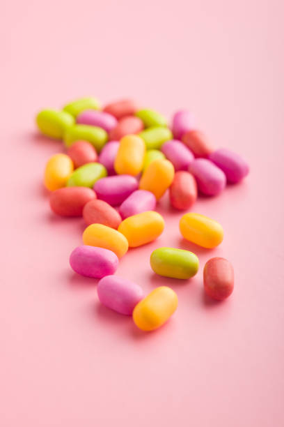 Colorful hard mint Candies on a pink background.