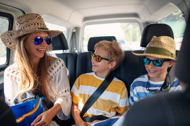 istock Three happy kids travelling to beach on a summer vacations day. 2158637059