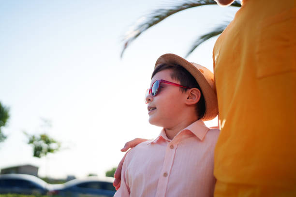 Pensive Caucasian boy looking through a window