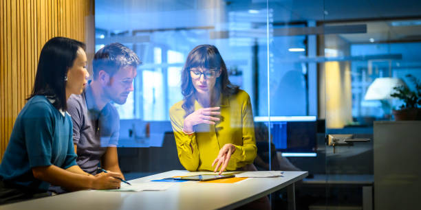 Diverse Team Engages in Strategy Discussion in Meeting Room