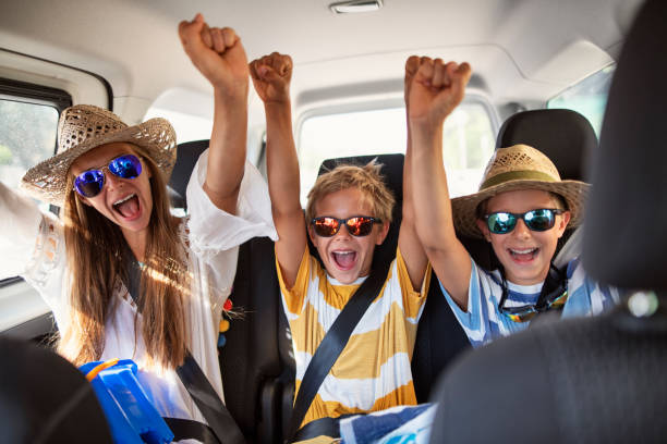 istock Three happy kids travelling to beach on a summer vacations day. 2158644785
