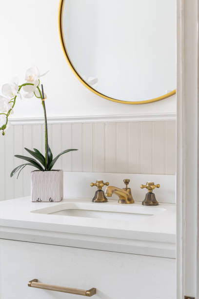 istock A bathroom with a white cabinet and gold accessories. 2158646813