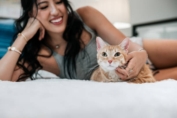 istock Woman Cuddles Cat At Home 2158649365